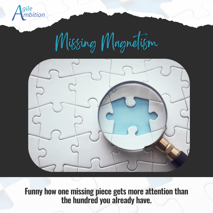 Puzzle with a missing piece under a magnifying glass, highlighting focus on gaps over progress.